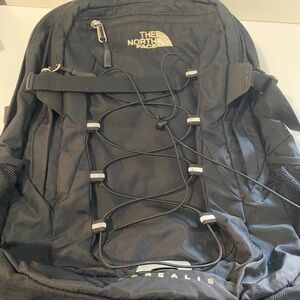 The Nort Face Black Backpack with Silver Zipper and Textured Design